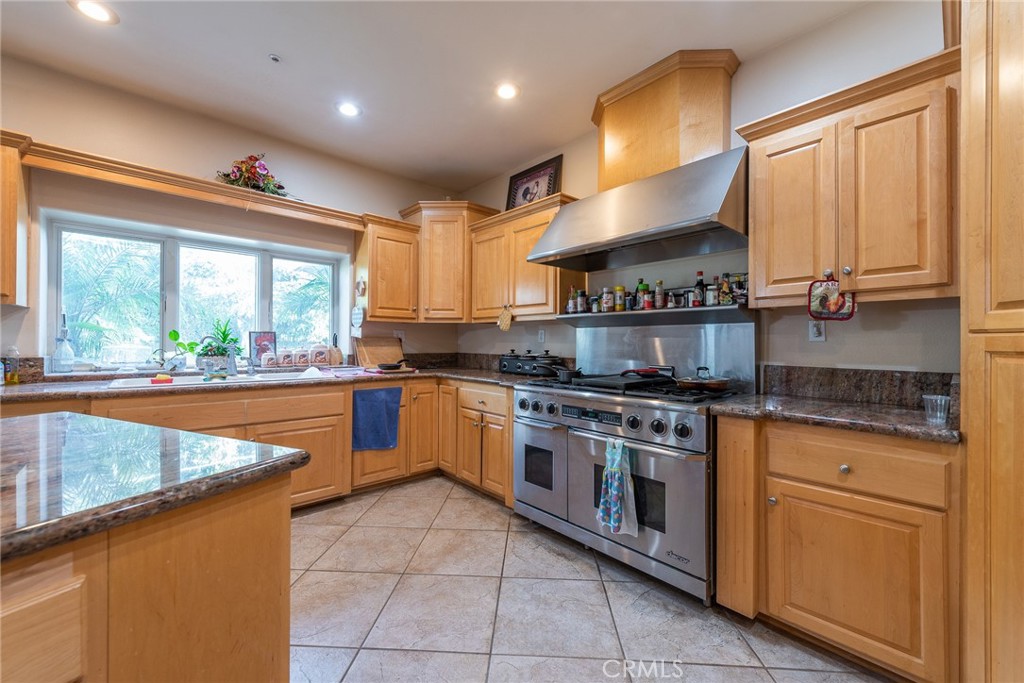 1413 Irving Street Riverside, CA 92504 - Photo 11 of 29 a kitchen with stainless steel appliances granite countertop a stove a sink and a microwave
