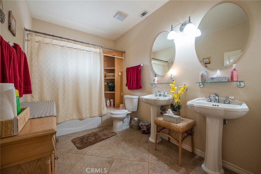 1413 Irving Street Riverside, CA 92504 - Photo 15 of 29 a living room with furniture and a mirror