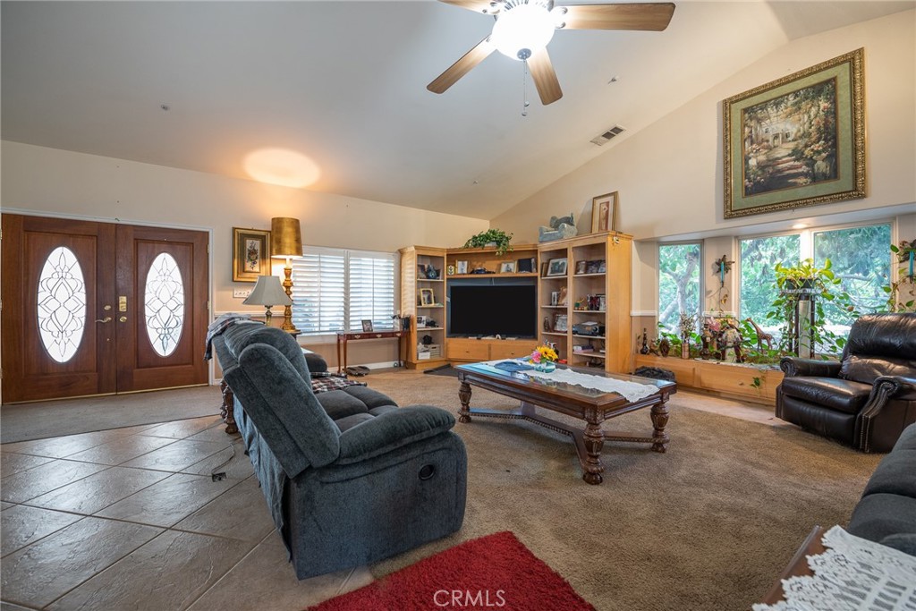 1413 Irving Street Riverside, CA 92504 - Photo 4 of 29 a living room with furniture a flat screen tv and a large window
