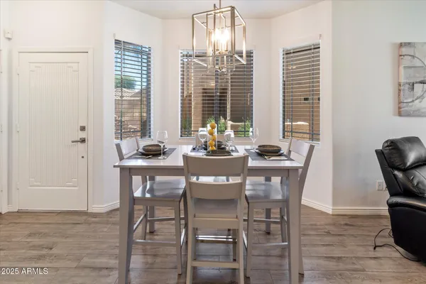 a kitchen with refrigerator and chairs