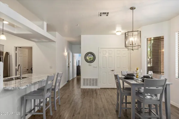 a kitchen with stainless steel appliances granite countertop a sink stove and cabinets