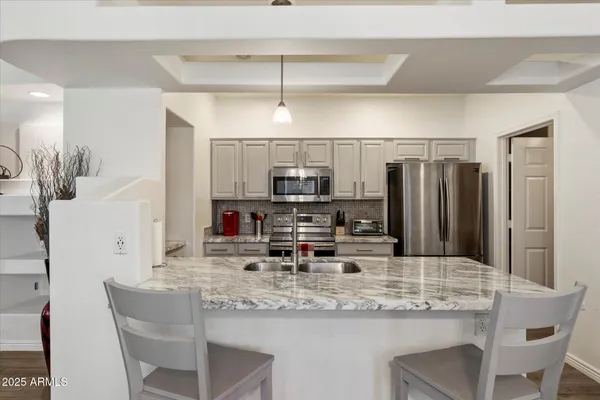 a bedroom with bed and a chandelier