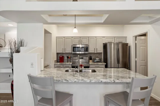 a bedroom with bed and a chandelier