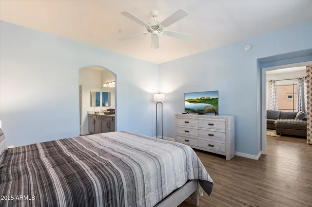 a bedroom with a bed and wooden floor