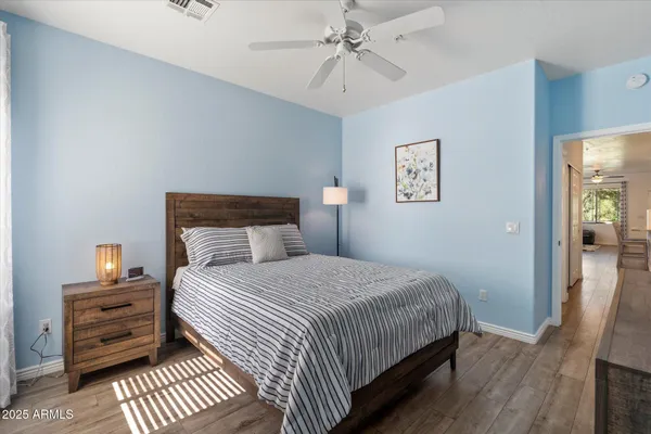 a bathroom with a granite countertop toilet sink and mirror