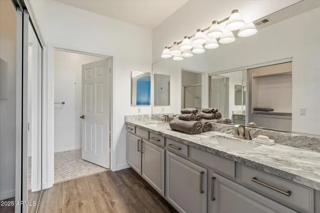 a bathroom with a double vanity sink and a mirror
