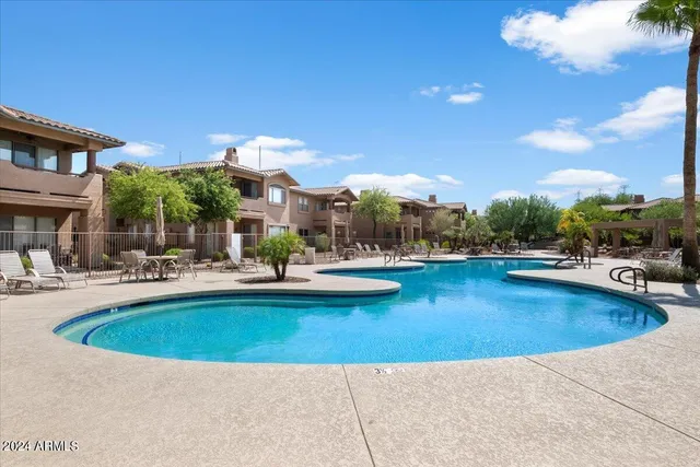 a view of a swimming pool with outdoor seating