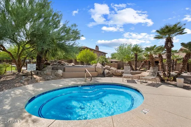 a view of a swimming pool with sitting area