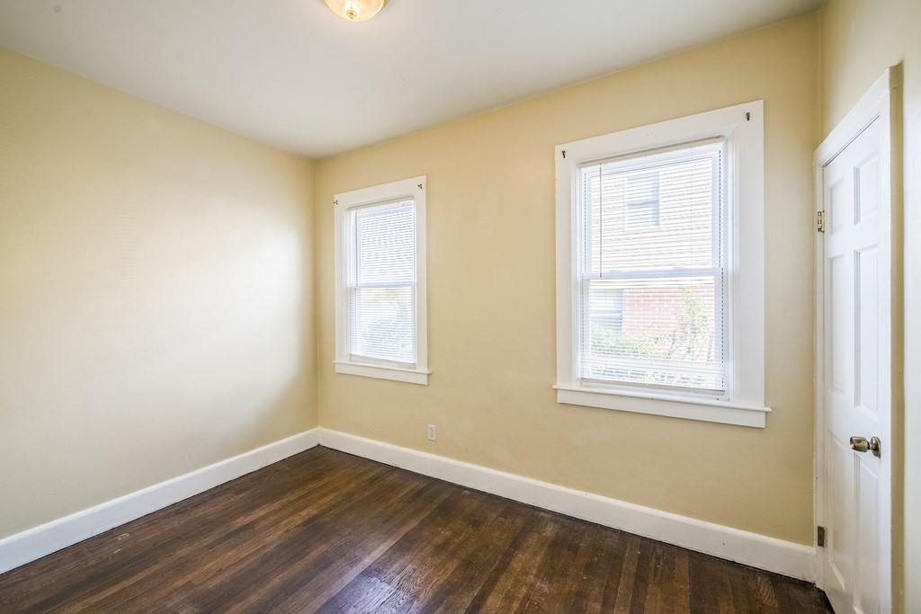 129 Florence Street Springfield, MA 01105 - Photo 11 of 16 a view of an empty room with wooden floor and a window