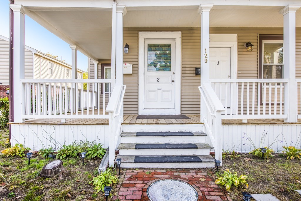 129 Florence Street Springfield, MA 01105 - Photo 2 of 16 a front view of a house with a garden
