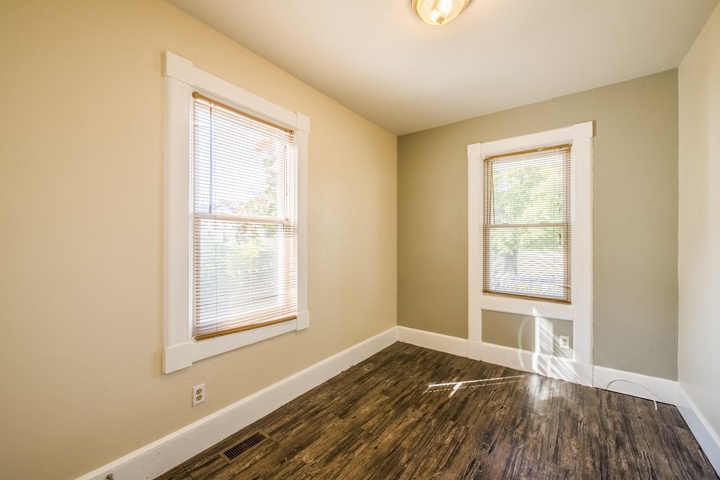 129 Florence Street Springfield, MA 01105 - Photo 5 of 16 a view of an empty room with wooden floor and a window