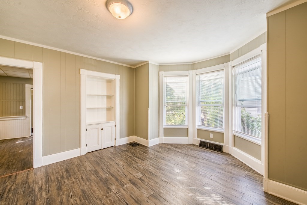 129 Florence Street Springfield, MA 01105 - Photo 7 of 16 a view of empty room with wooden floor and fan