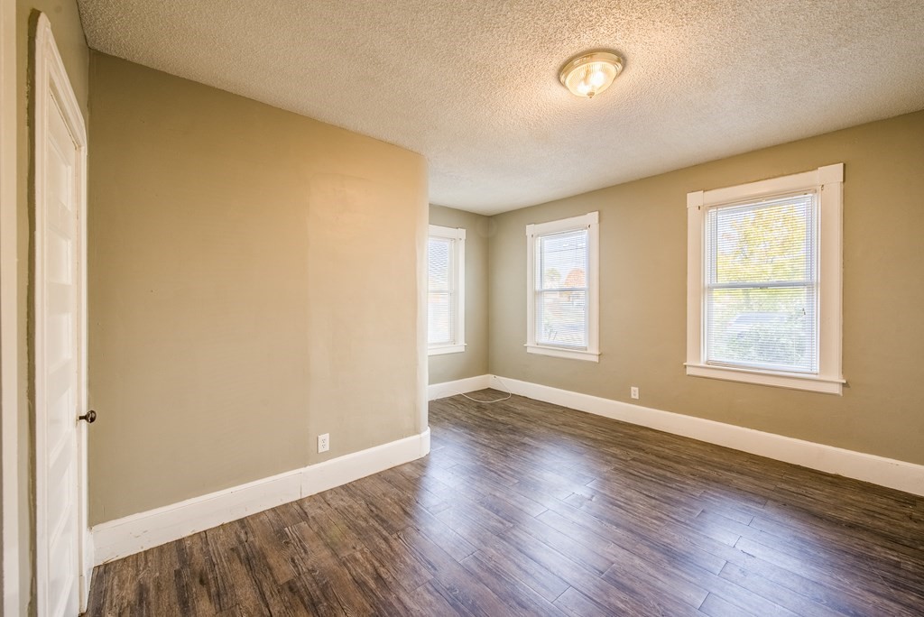 129 Florence Street Springfield, MA 01105 - Photo 8 of 16 an empty room with wooden floor and windows
