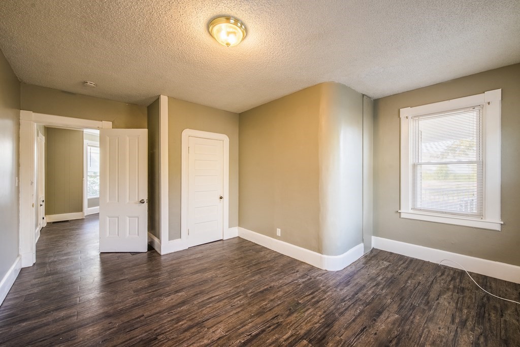 129 Florence Street Springfield, MA 01105 - Photo 9 of 16 an empty room with wooden floor and windows