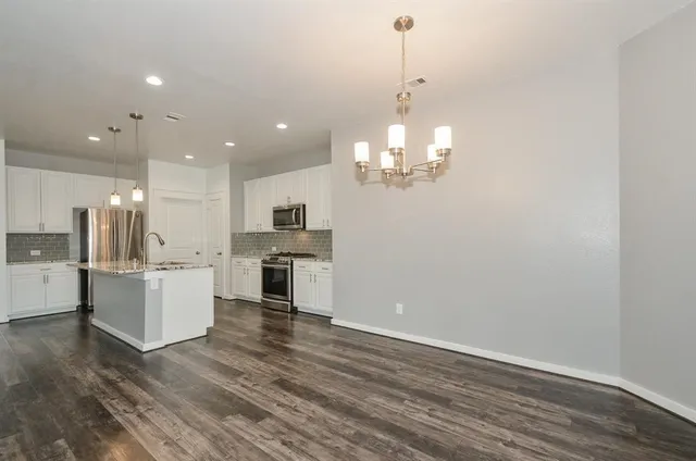 a stove top oven sitting inside of a kitchen