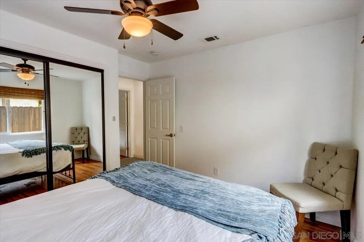 861 Shade Tree Lane Fallbrook, CA 92028 - Photo 18 of 49 a bedroom with a bed and a chandelier