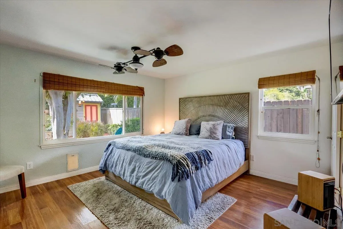861 Shade Tree Lane Fallbrook, CA 92028 - Photo 19 of 49 a bedroom with a large bed a chandelier and a window