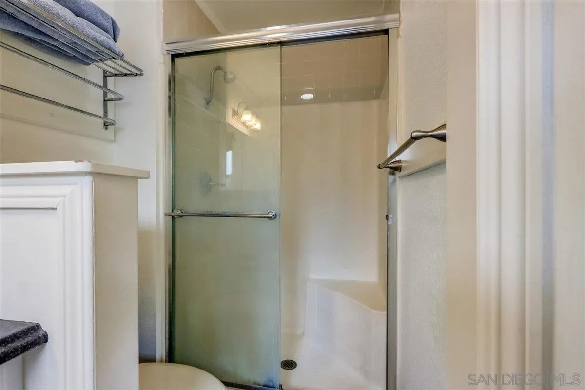 861 Shade Tree Lane Fallbrook, CA 92028 - Photo 23 of 49 a bathroom with a glass shower door