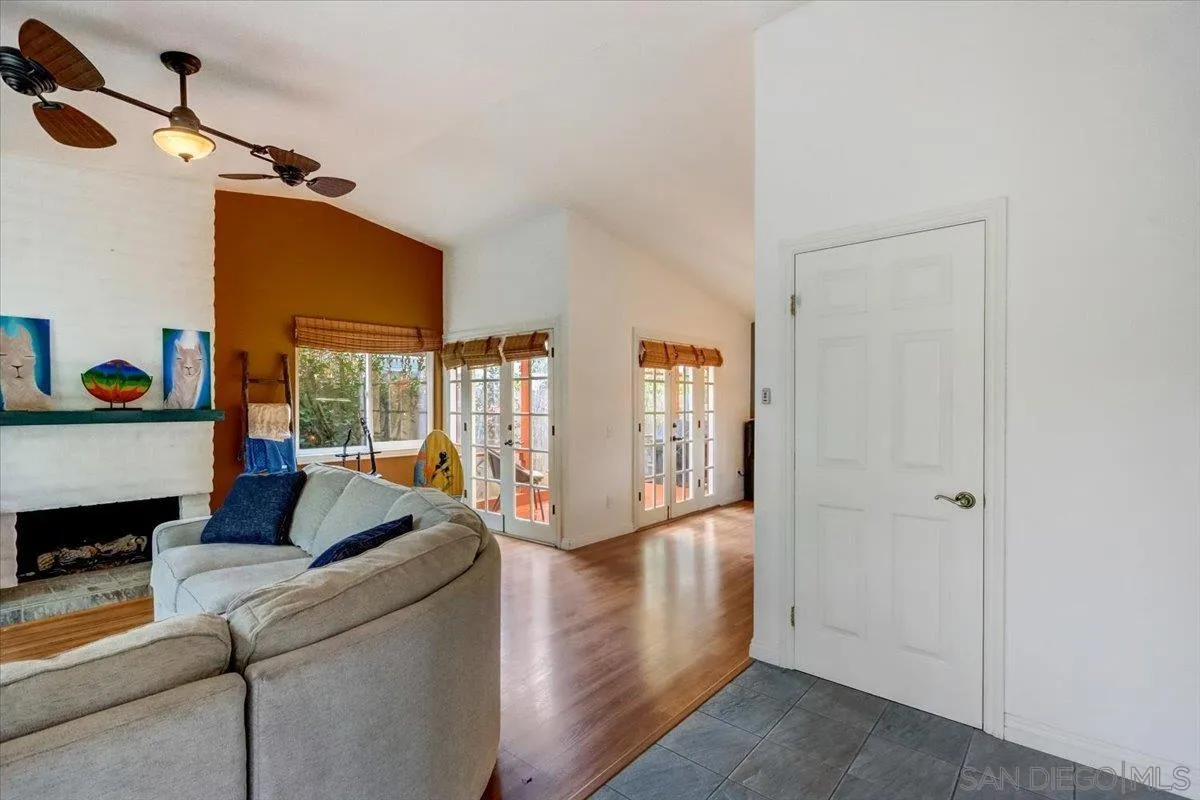 861 Shade Tree Lane Fallbrook, CA 92028 - Photo 3 of 49 a living room with furniture a flat screen tv and a floor to ceiling window