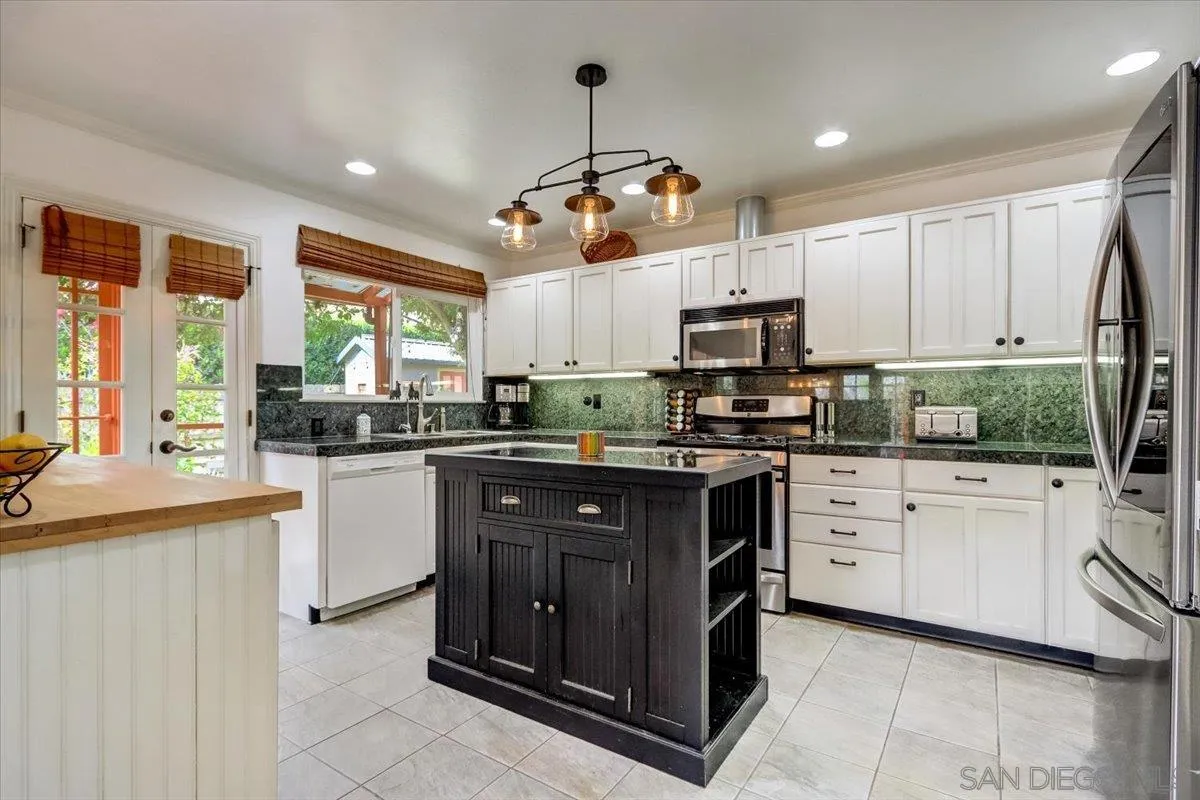 861 Shade Tree Lane Fallbrook, CA 92028 - Photo 10 of 49 a kitchen with granite countertop a sink and steel appliances