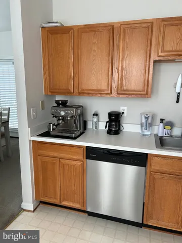 a kitchen with stainless steel appliances granite countertop a sink a stove and white cabinets