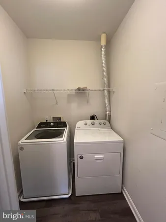 an empty room with windows and ceiling fan