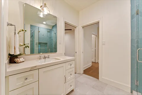 a bathroom with a granite countertop sink a toilet and a mirror