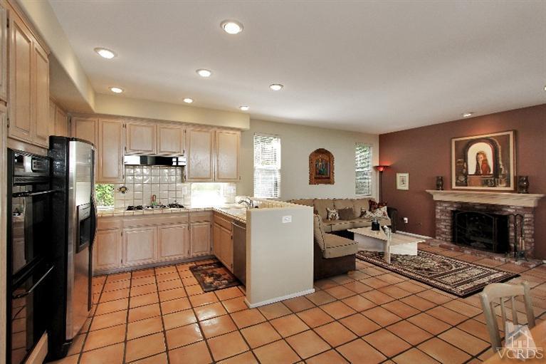 3853 Timberridge Road Moorpark, CA 93021 - Photo 11 of 42 a kitchen with a refrigerator and a stove top oven