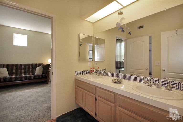 3853 Timberridge Road Moorpark, CA 93021 - Photo 21 of 42 a bathroom with a double vanity sink and a mirror