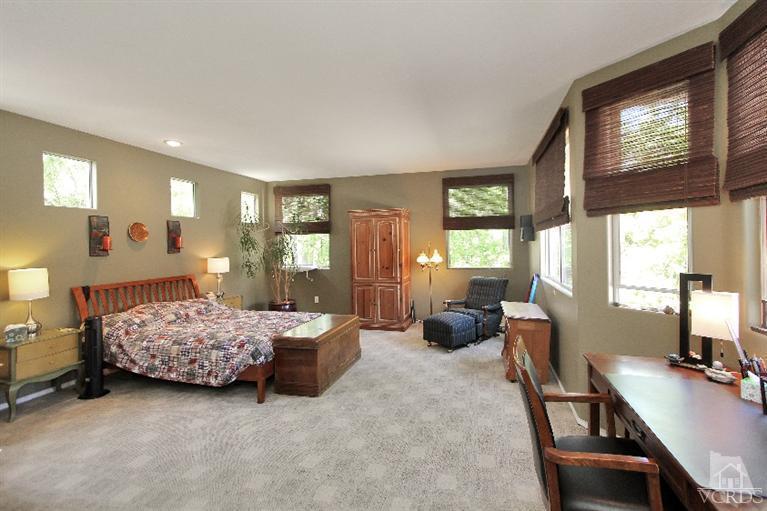 3853 Timberridge Road Moorpark, CA 93021 - Photo 26 of 42 a bedroom with a bed and large windows