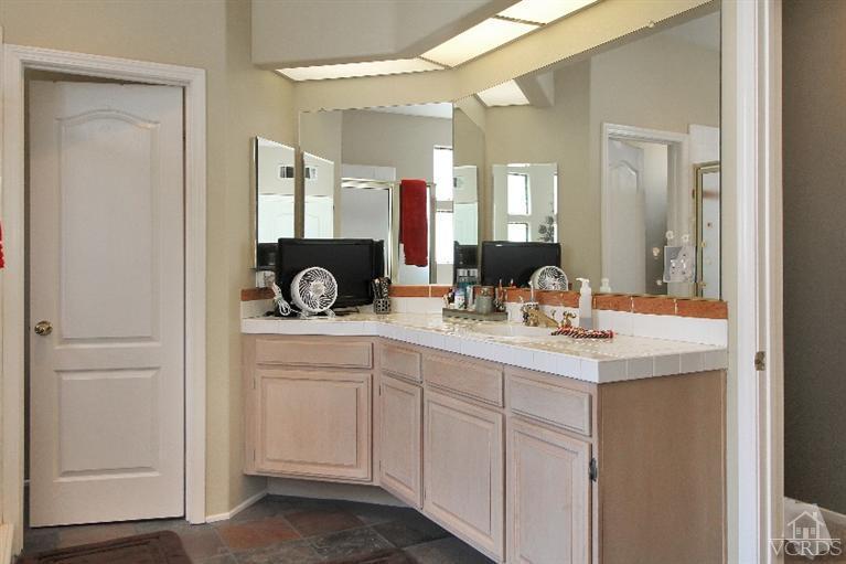 3853 Timberridge Road Moorpark, CA 93021 - Photo 31 of 42 a bathroom with a double vanity sink and a mirror