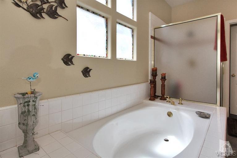 3853 Timberridge Road Moorpark, CA 93021 - Photo 34 of 42 a bathroom with a tub and a shower