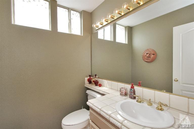 3853 Timberridge Road Moorpark, CA 93021 - Photo 10 of 42 a bathroom with a sink vanity mirror and toilet