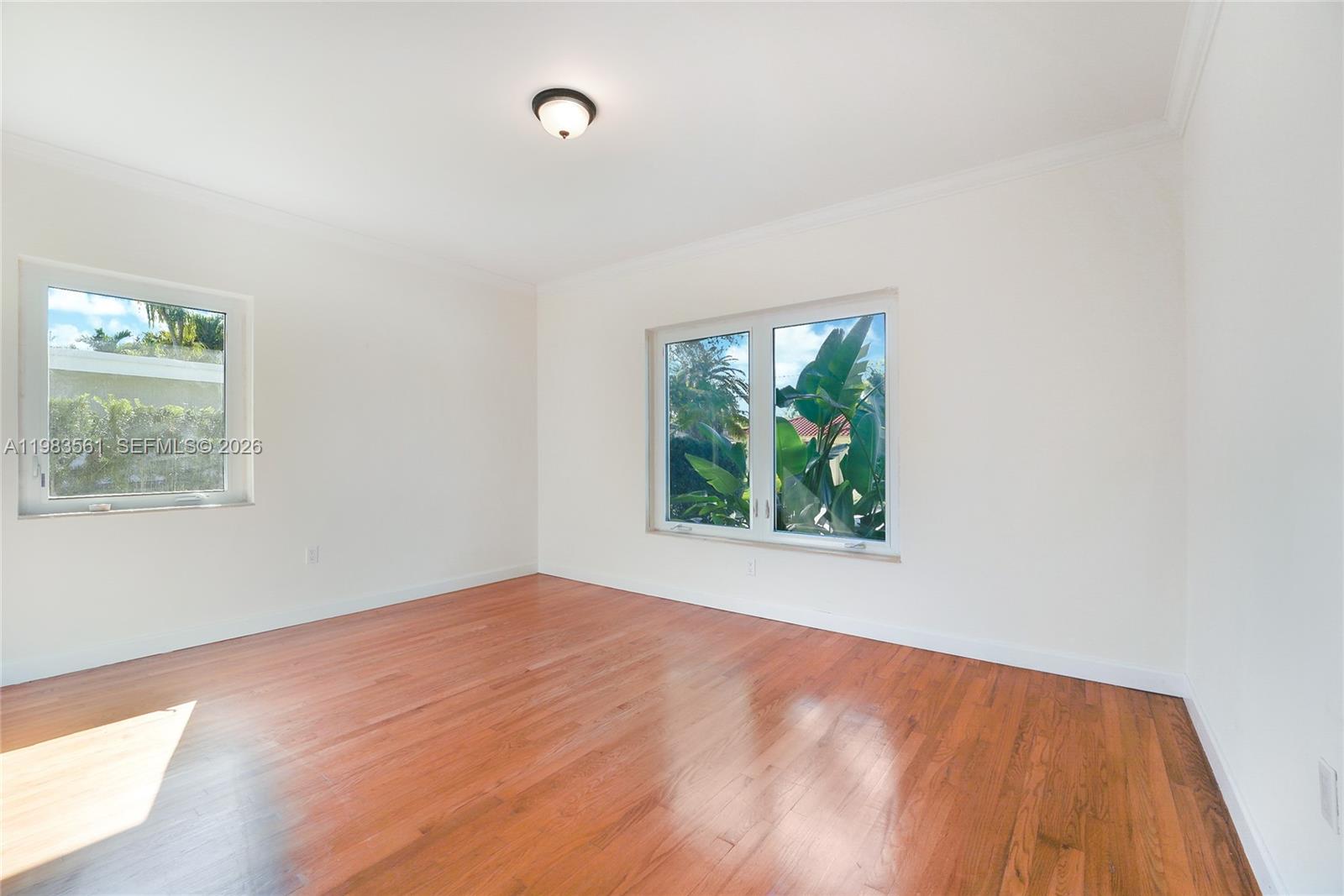 8975 Froude Avenue Surfside, FL 33154 - Photo 11 of 18 an empty room with a window