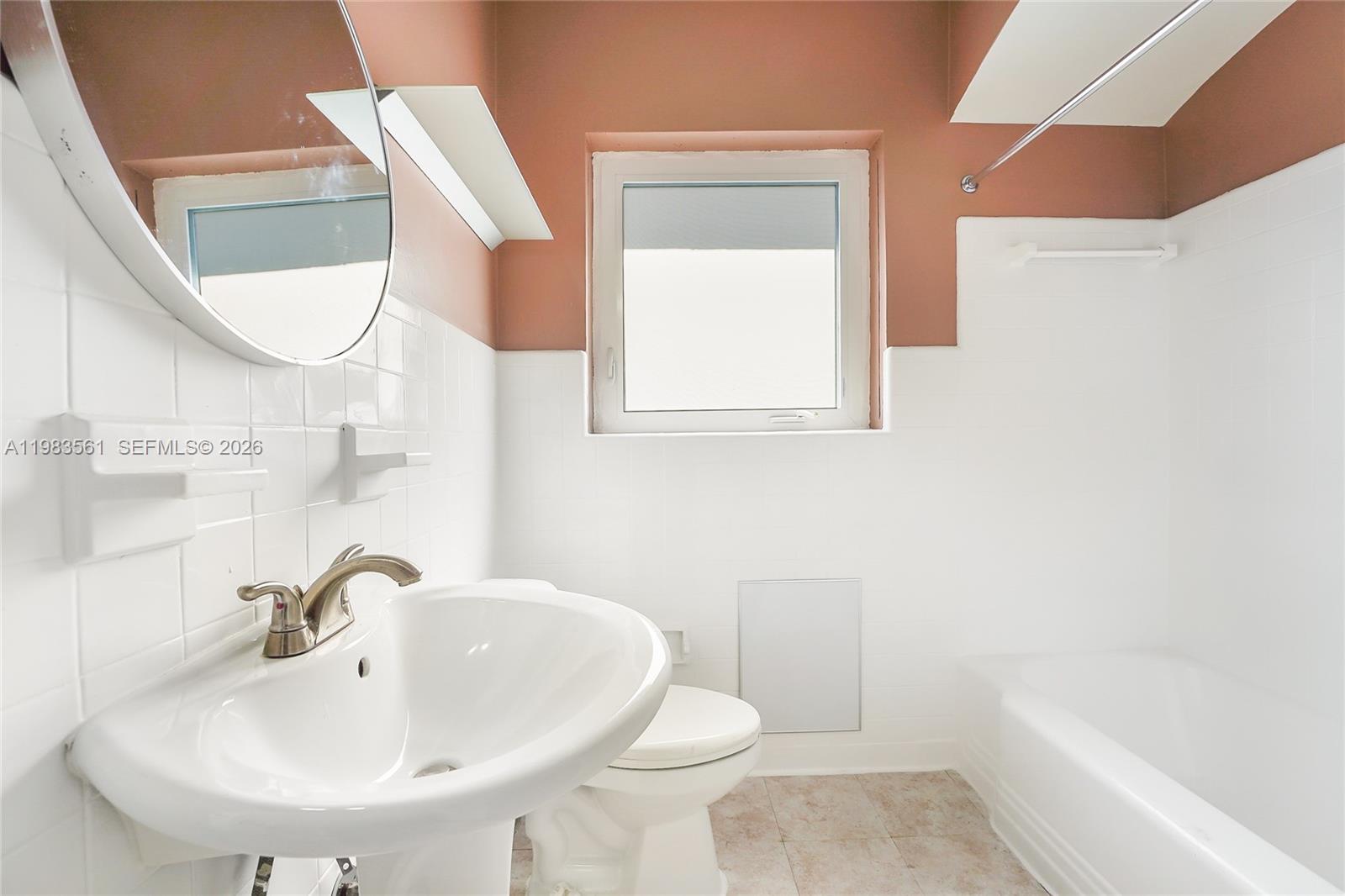 8975 Froude Avenue Surfside, FL 33154 - Photo 14 of 18 a bathroom with a sink a toilet and a bathtub