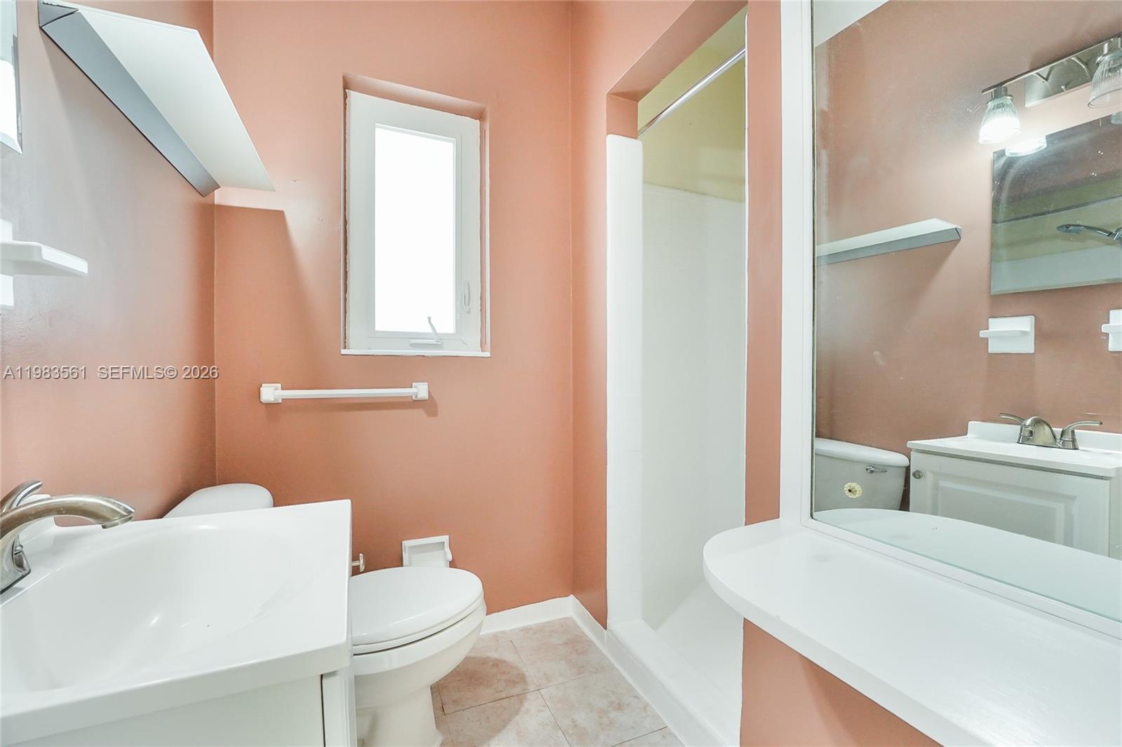 8975 Froude Avenue Surfside, FL 33154 - Photo 15 of 18 a bathroom with a sink a toilet and mirror