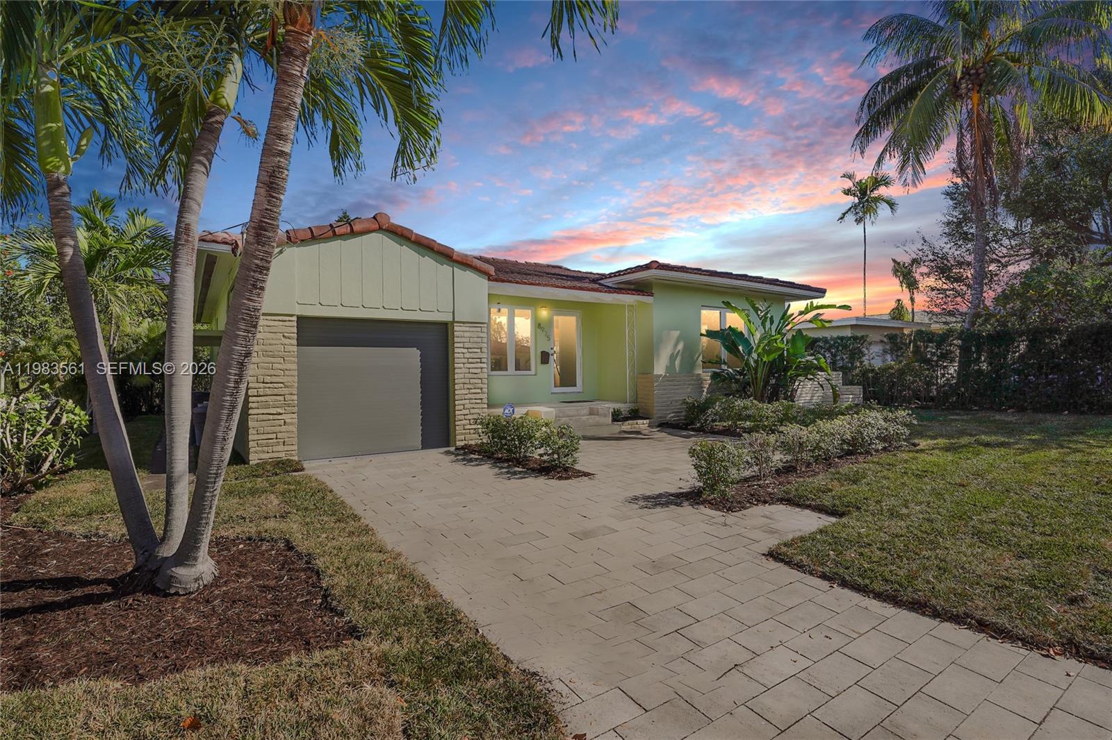 8975 Froude Avenue Surfside, FL 33154 - Photo 18 of 18 a front view of a house with garden