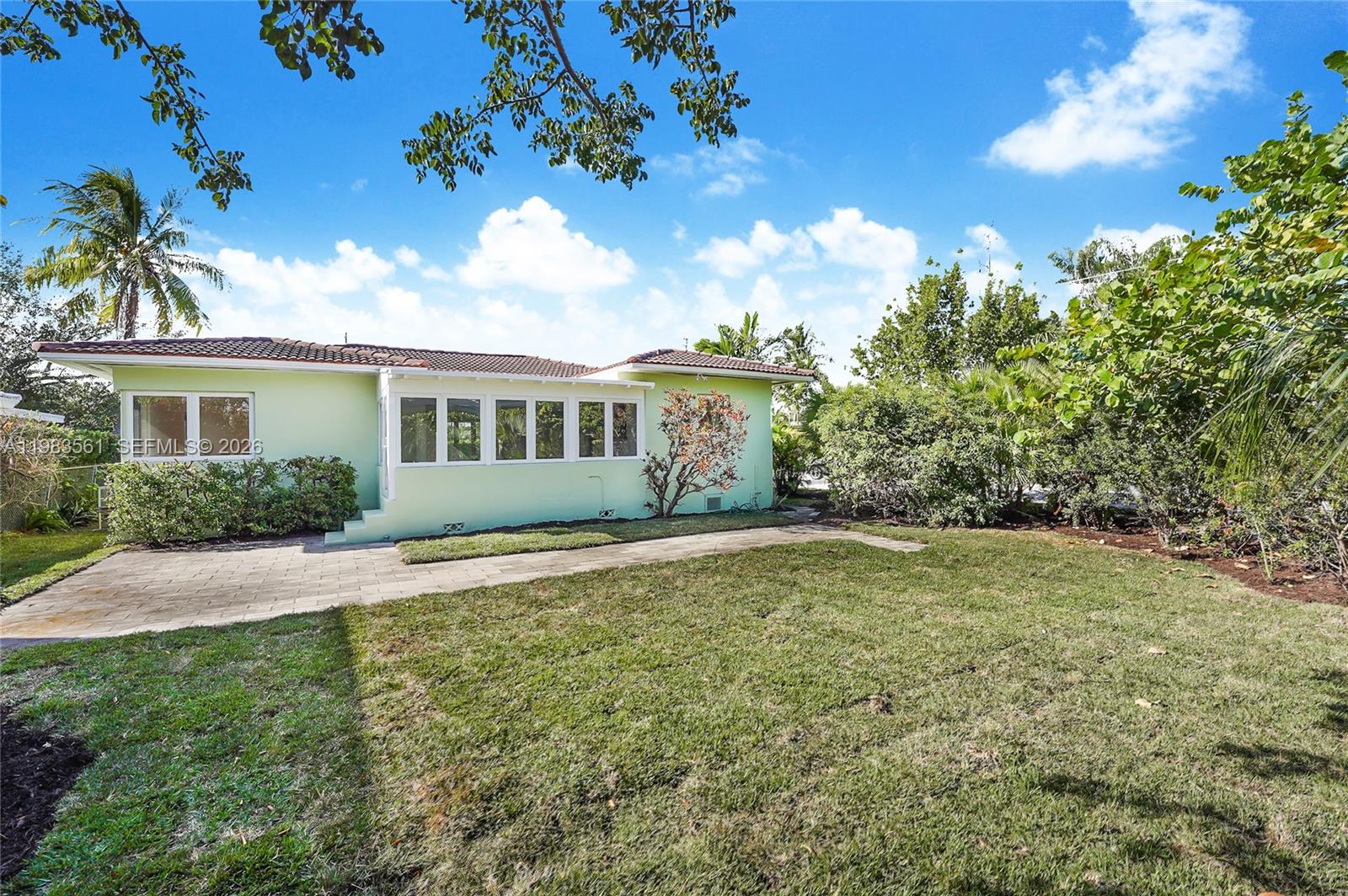 8975 Froude Avenue Surfside, FL 33154 - Photo 2 of 18 a house view with a garden space