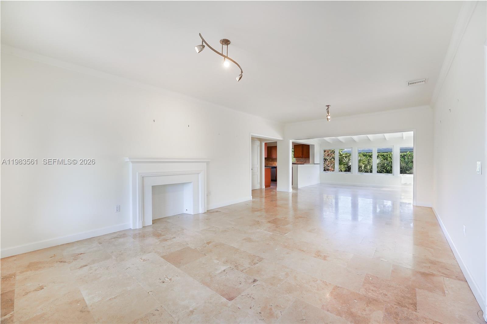 8975 Froude Avenue Surfside, FL 33154 - Photo 5 of 18 a view of an empty room with window and wooden floor