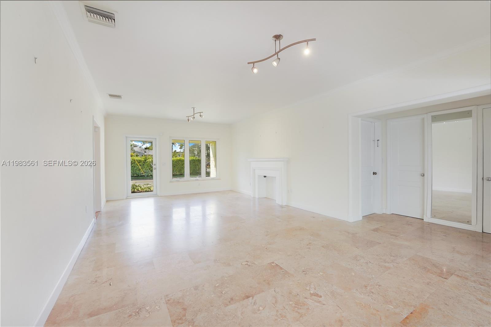 8975 Froude Avenue Surfside, FL 33154 - Photo 9 of 18 wooden floor in an empty room with a window