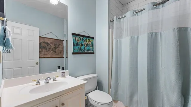 a bathroom with a sink mirror vanity and toilet