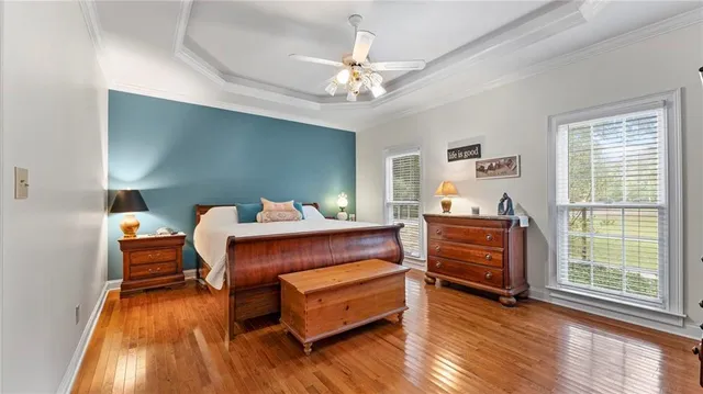a bedroom with furniture and wooden floor