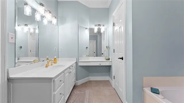 a bathroom with a double vanity sink mirror and bathtub