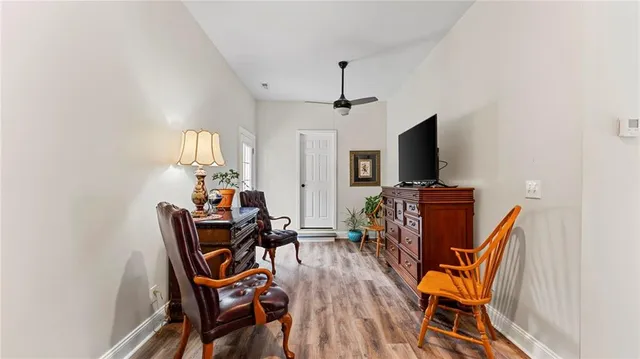 a view of a dining room with furniture and wooden floor