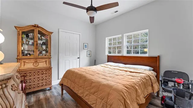 a bedroom with a bed and wooden floor