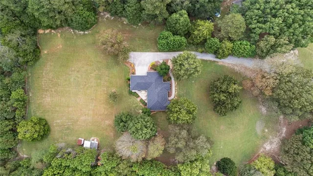 an aerial view of a house with a yard and lake view