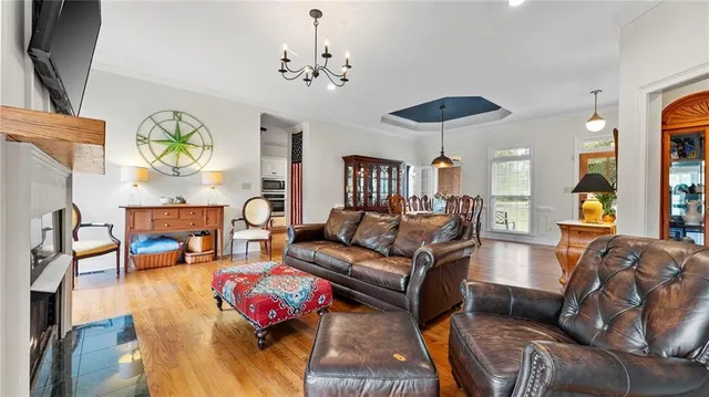 a living room with furniture and a chandelier