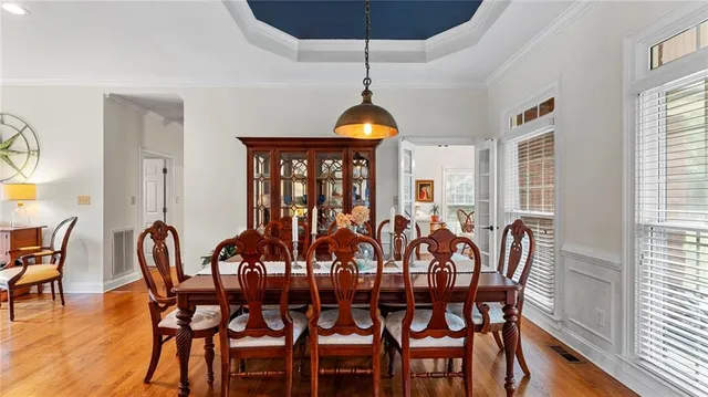 a view of a dining room with furniture window and wooden floor