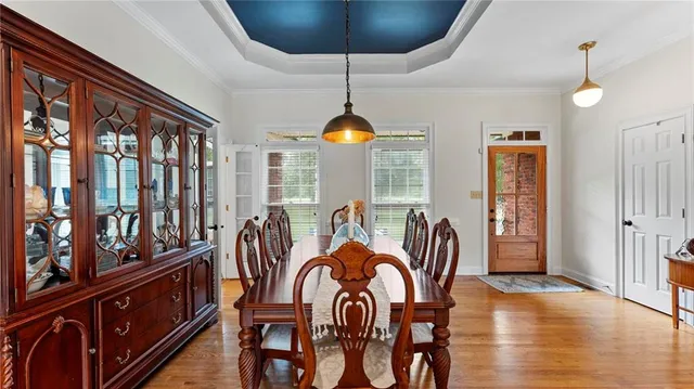 a dining room with furniture window and wooden floor