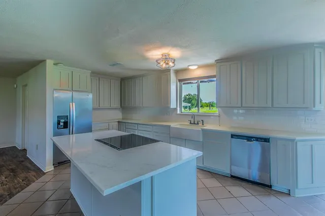 a kitchen with a stove and a refrigerator